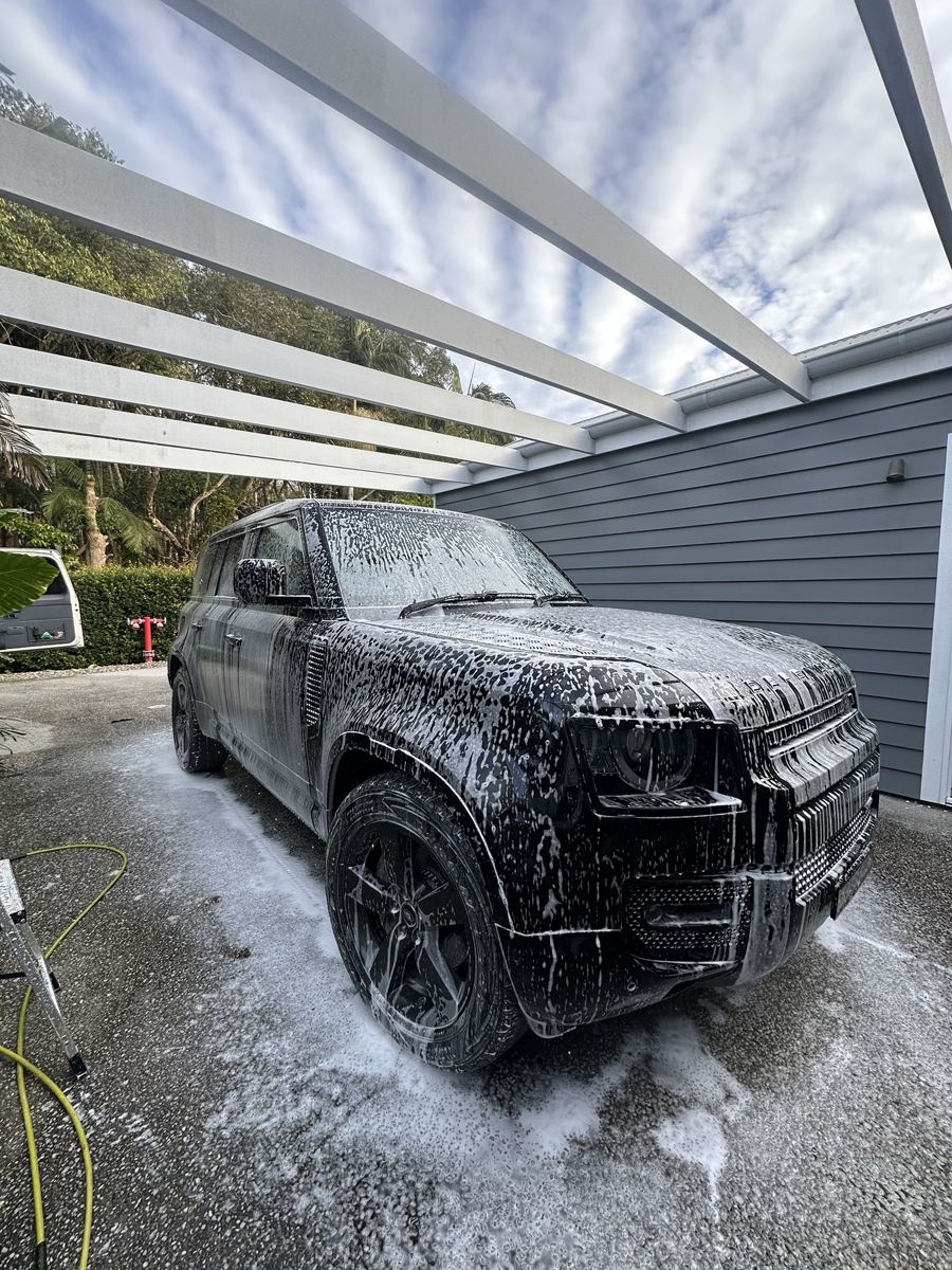 Land Rover Defender covered in snow foam during a hand wash in Byron Bay