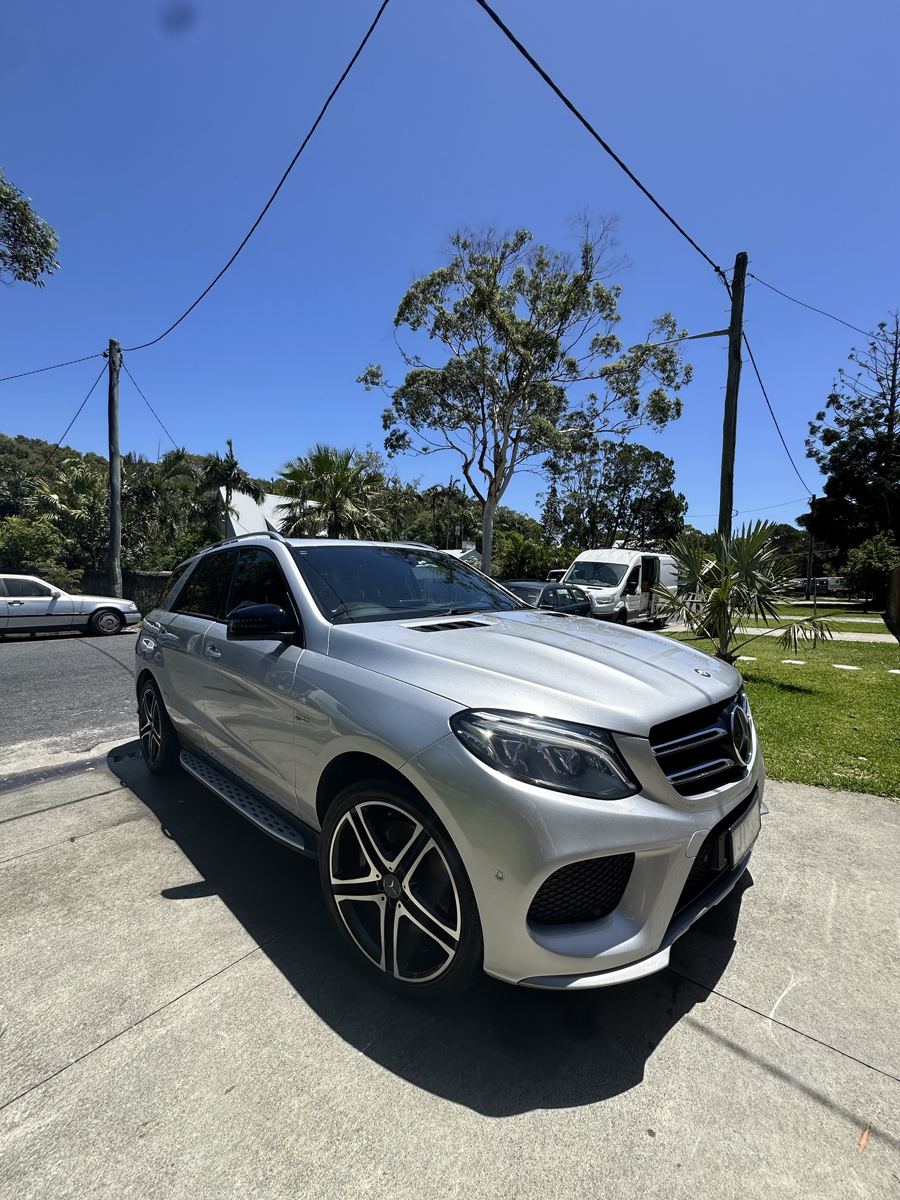 Silver Mercedes SUV washed in a driveway